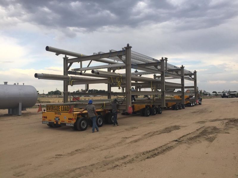 Fabricated pipe rack modules loaded on flatbed trailers