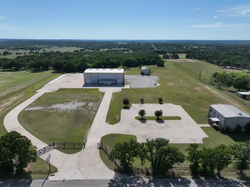 Aerial view of the Integrity Fabrication shop, yard, and office building in Millsap, Texas